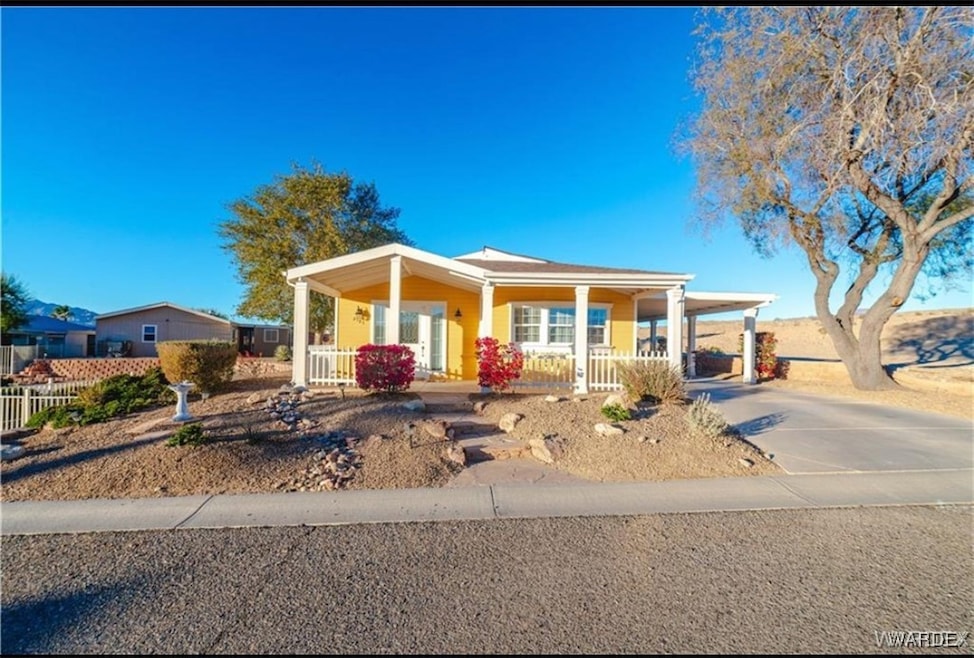 View of front of house with a carport and covered