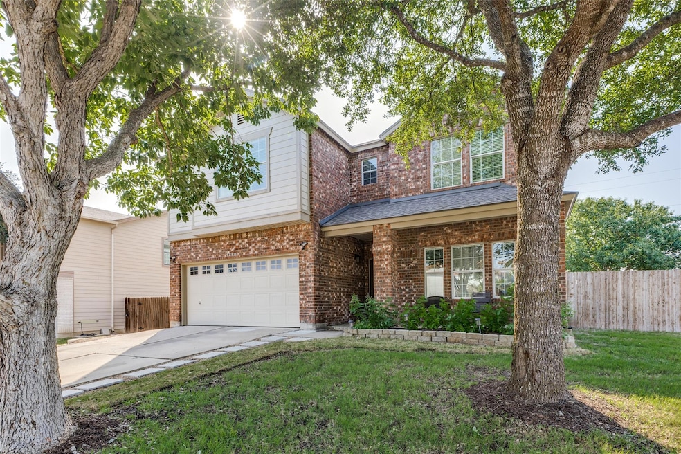 View of front of home with concrete driveway, a g