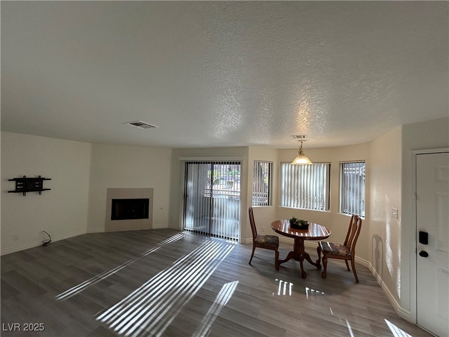 Living area with wood finished floors, a tiled fir
