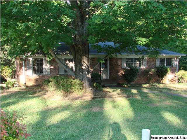Front view of the property, with driveway on left