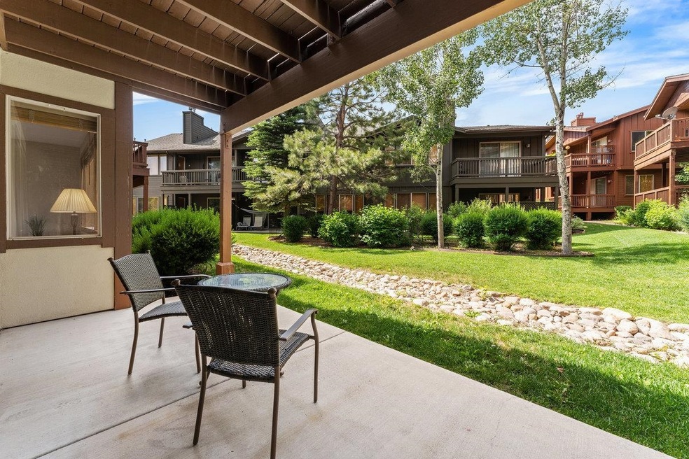 Patio opens to a grassy lawn area.