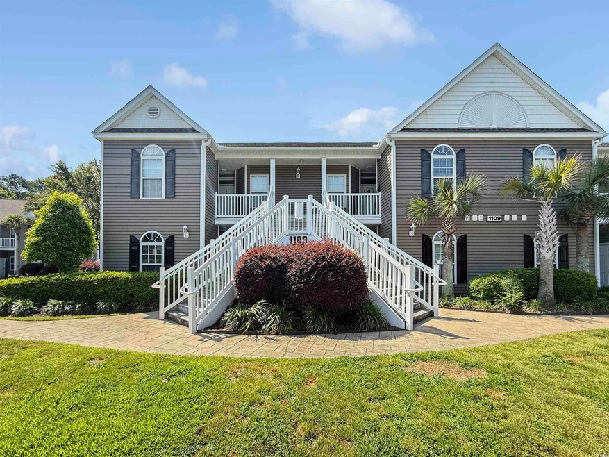 View of front facade featuring stairs, a front law