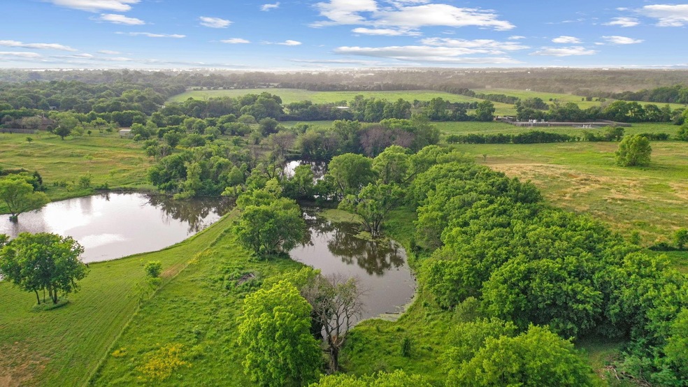 Birds eye view of property with a water view and a
