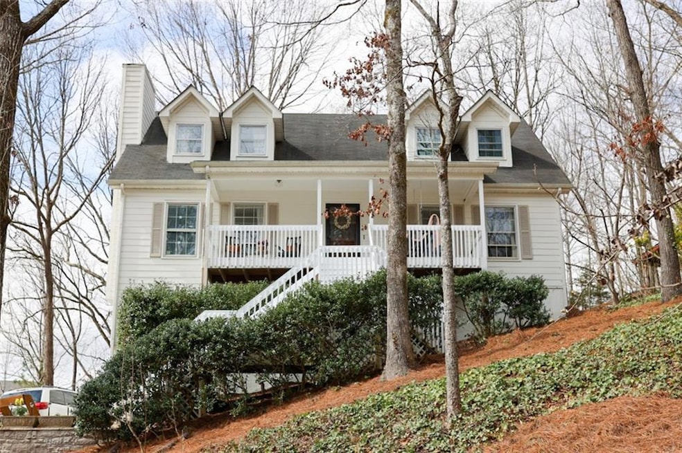 Cape cod-style house with a porch