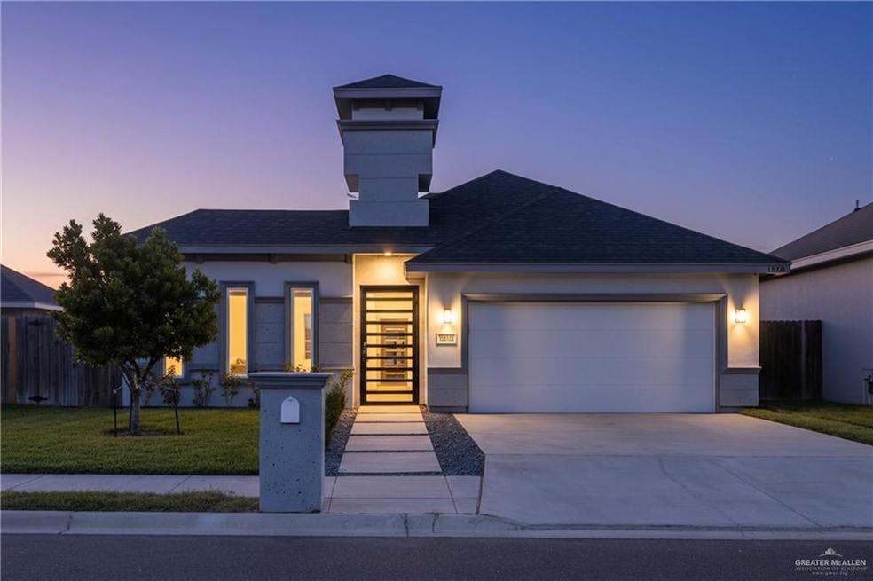 View of front of house featuring a shingled roof, concrete driveway, an attached garage, and stucco siding