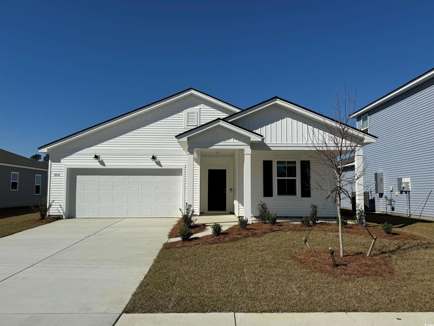 View of front facade featuring driveway, board and