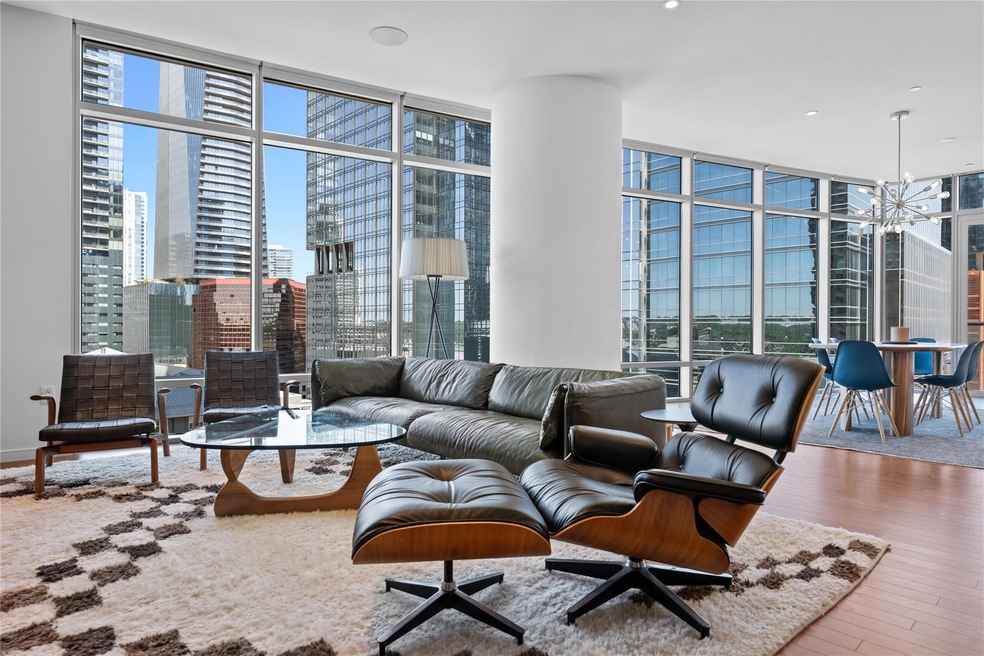 Living room featuring floor to ceiling windows, a