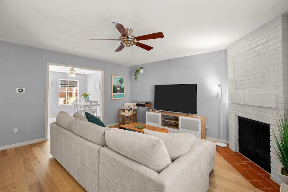 Living room featuring a fireplace, light wood-sty