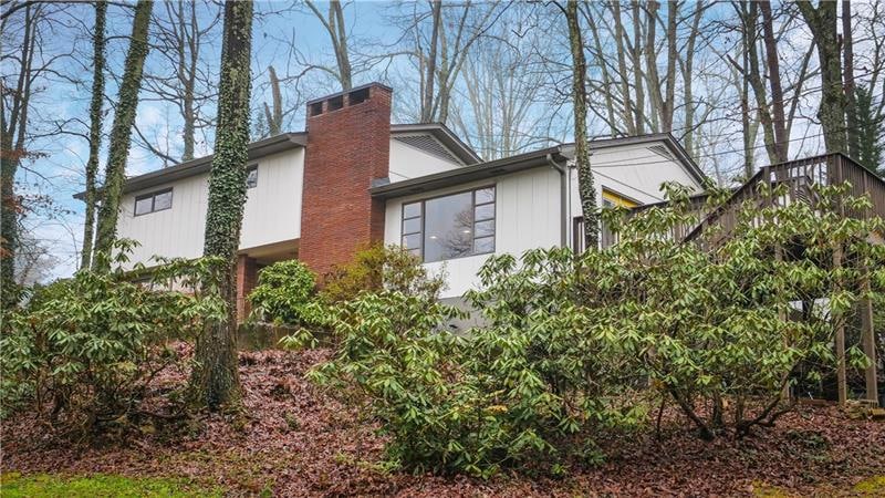 Front of home with natural foliage landscaping.