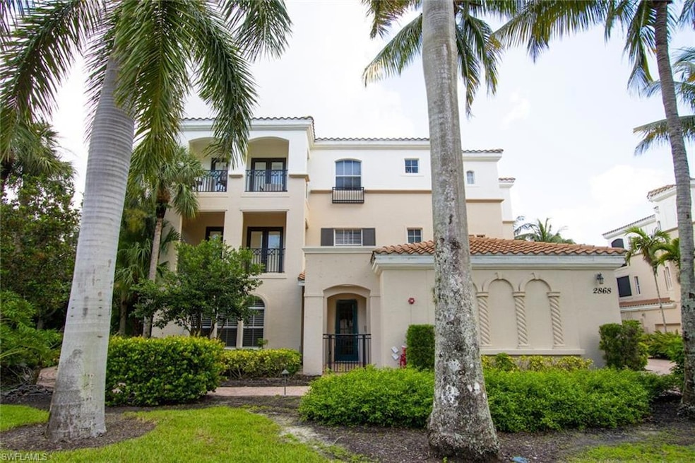 View of front of home featuring a tile roof and stucco siding