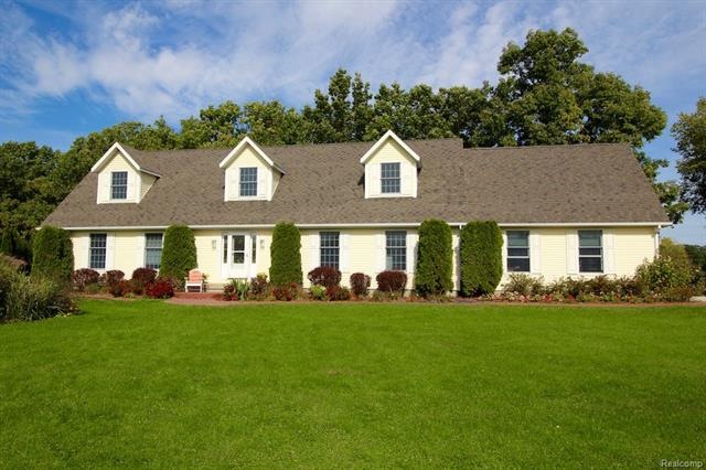 Broad and spacious front lawn frames the front ent