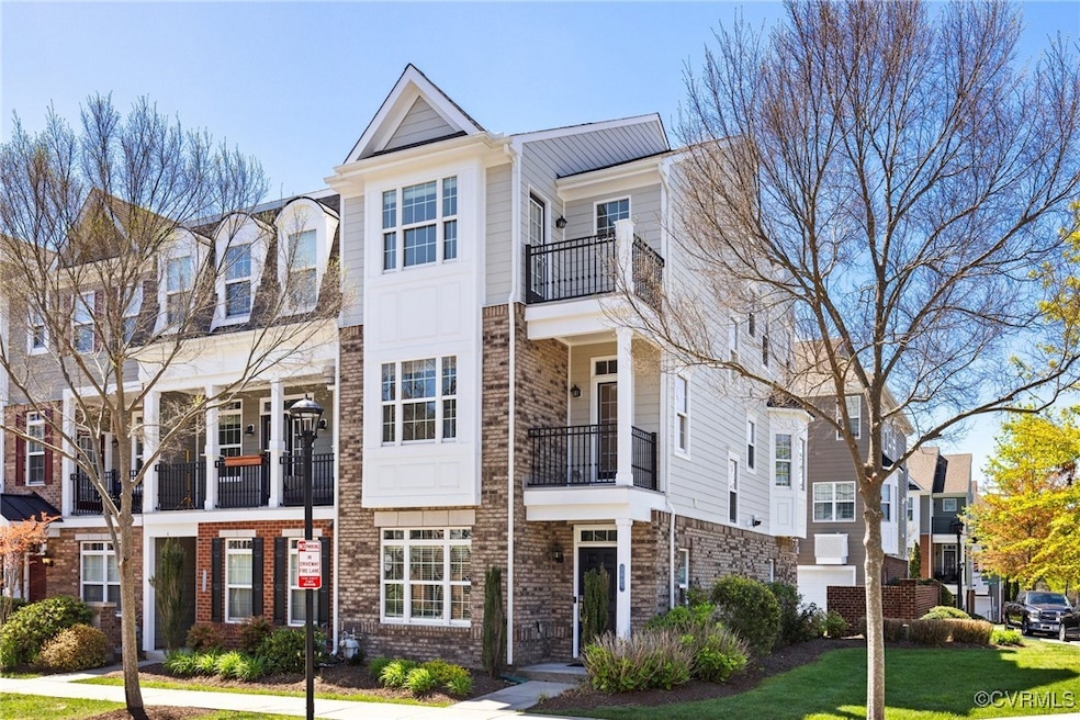 View of property featuring brick siding, a front l
