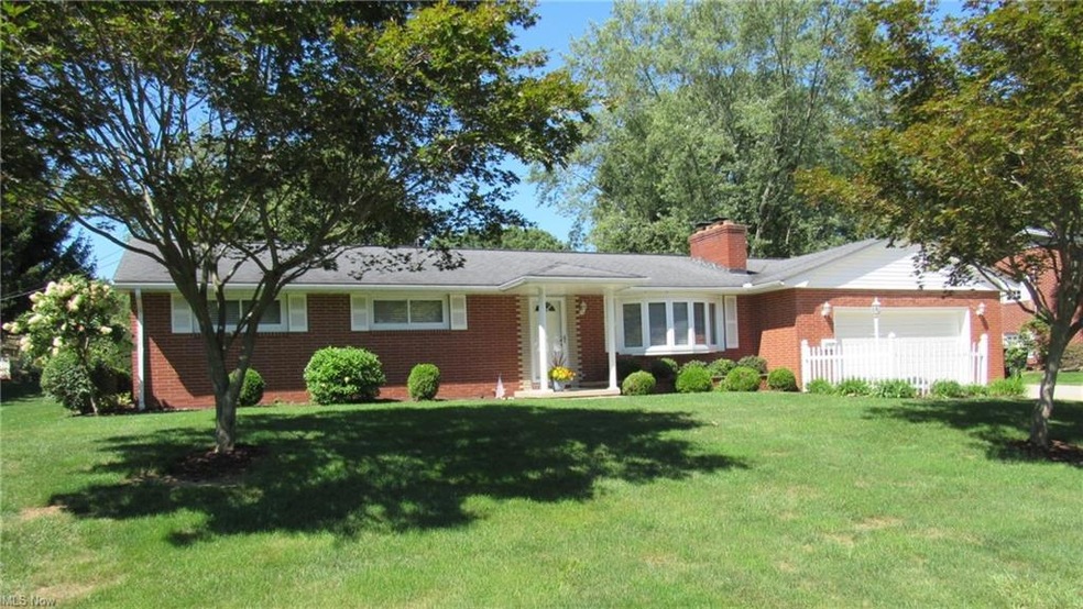 Ranch-style home with garage and a front yard