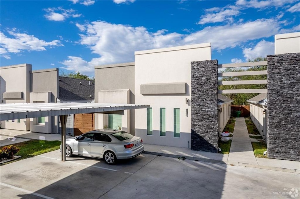 View of property featuring covered parking