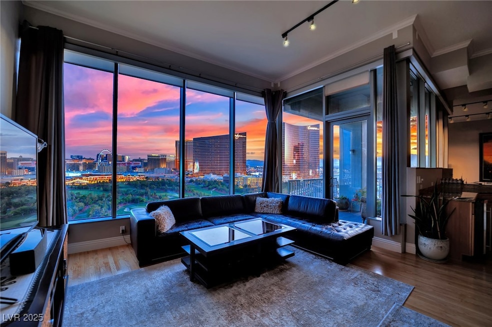 Living room featuring rail lighting, crown molding
