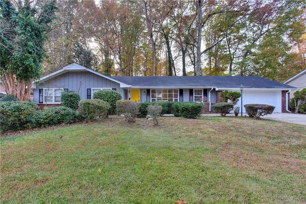 Ranch-style home with a front yard and a garage