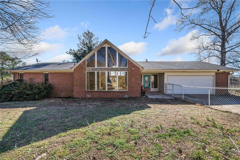 View of front of house with a garage and a front y