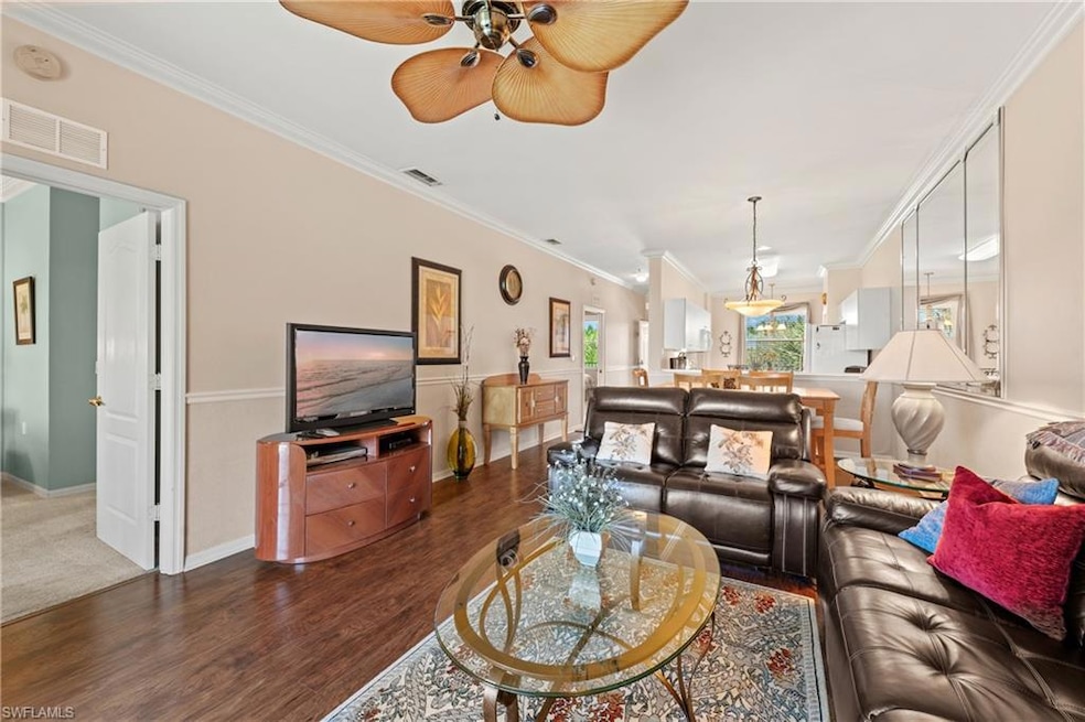Living room with ornamental molding, ceiling fan, 