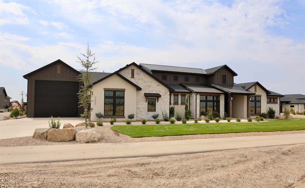 Modern inspired farmhouse with concrete driveway, a metal roof, stone siding, an attached garage, and a front yard