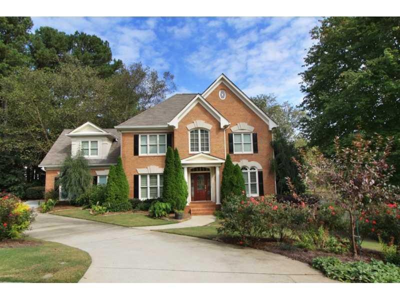 Exterior Front. Professionally landscaped with wat
