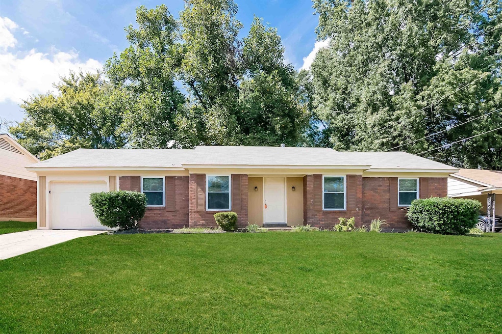Ranch-style home with brick siding, a front lawn, a garage, and concrete driveway