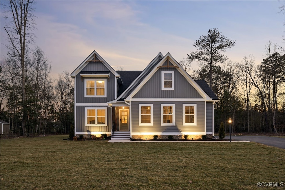 Craftsman house featuring a lawn and driveway
