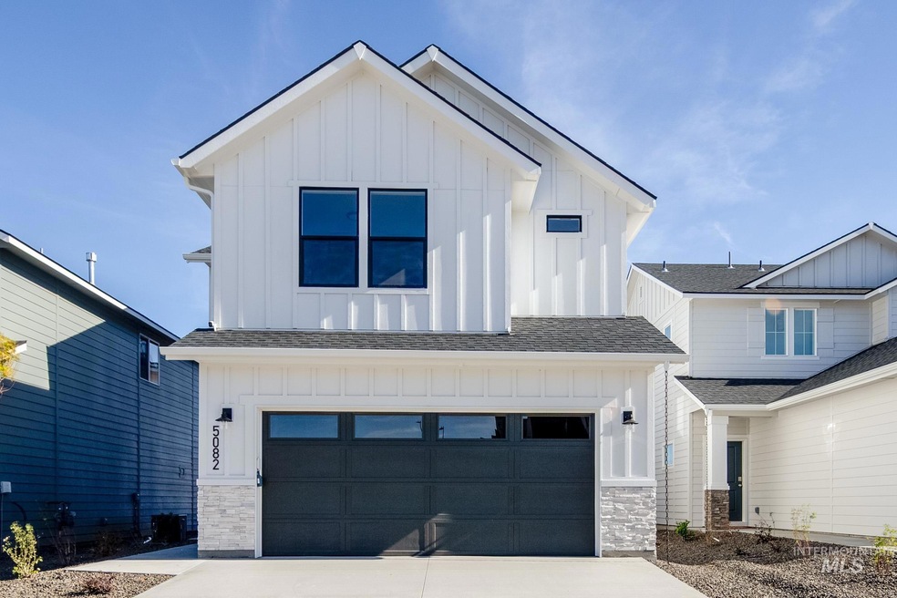 View of front of home featuring board and batten siding, roof with shingles, a garage, and concrete driveway
