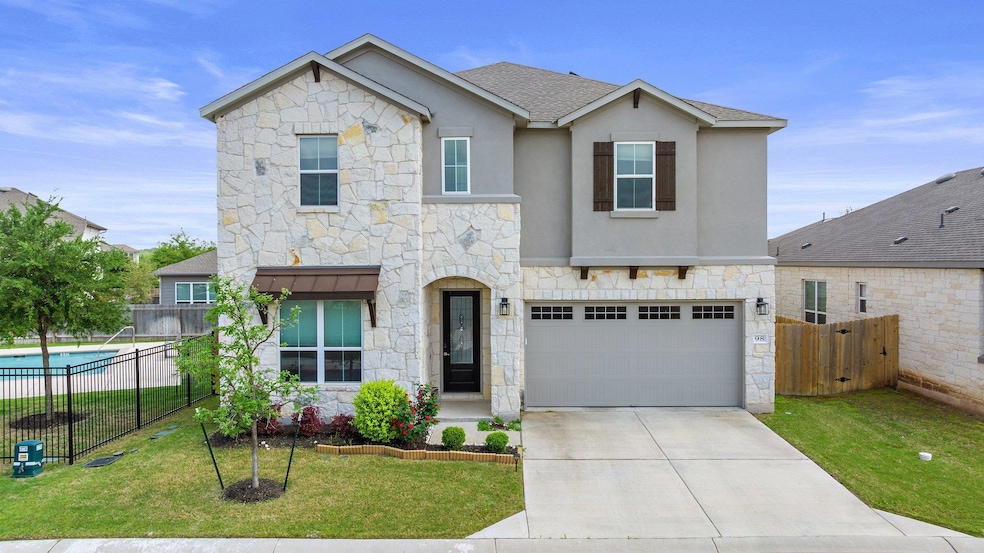 Traditional-style home featuring a garage, stone 