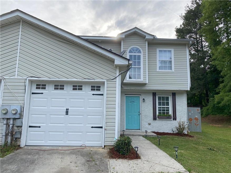 View of front facade featuring a garage, a front l