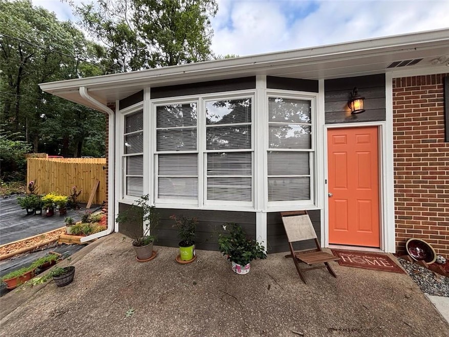 Doorway to property featuring brick siding and beautiful bay windows