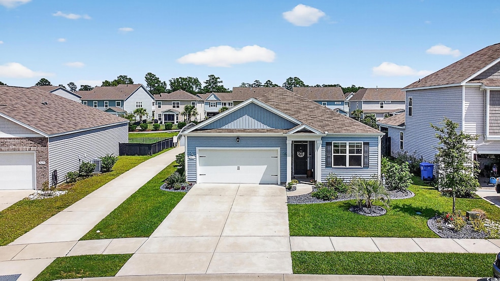 View of front of property with a residential view, driveway, and a garage