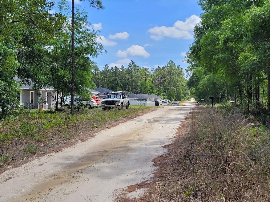 Houses 2 lots away from property. View from Land.