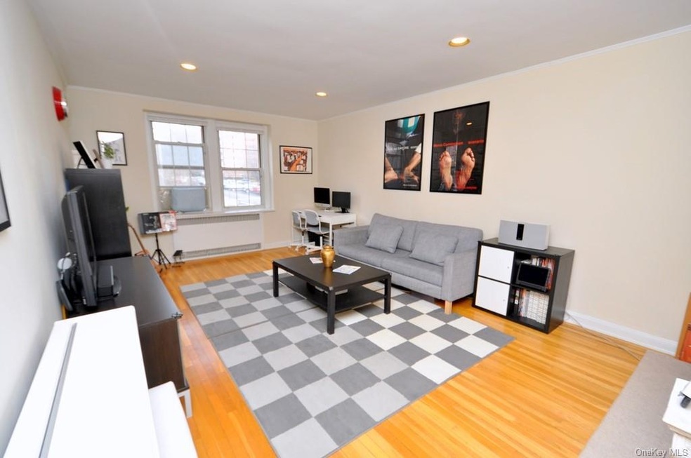 Large bright living room has refinished hardwood f