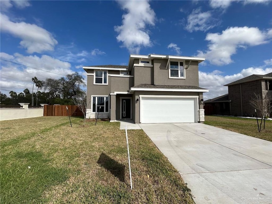 View of front of home featuring stucco siding, concrete driveway, and a garage