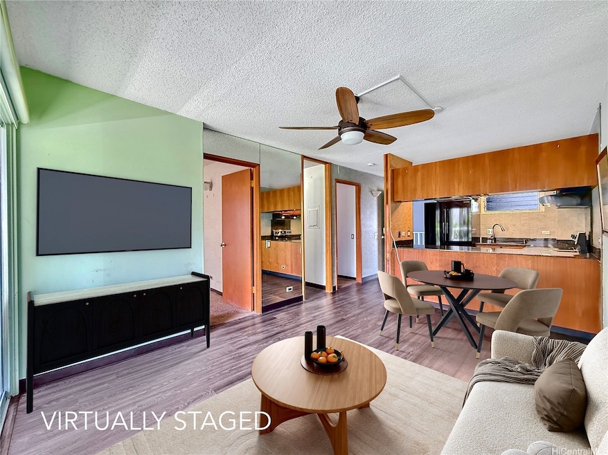 Spacious living room and open kitchen with island.