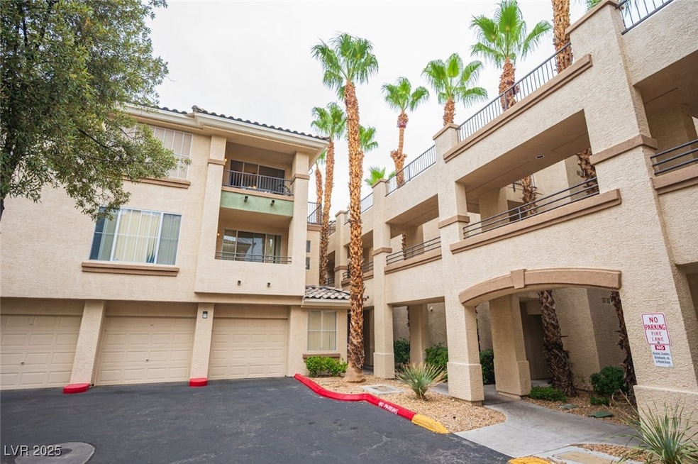 View of property featuring an attached garage and driveway