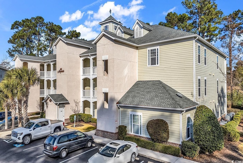 View of property featuring uncovered parking