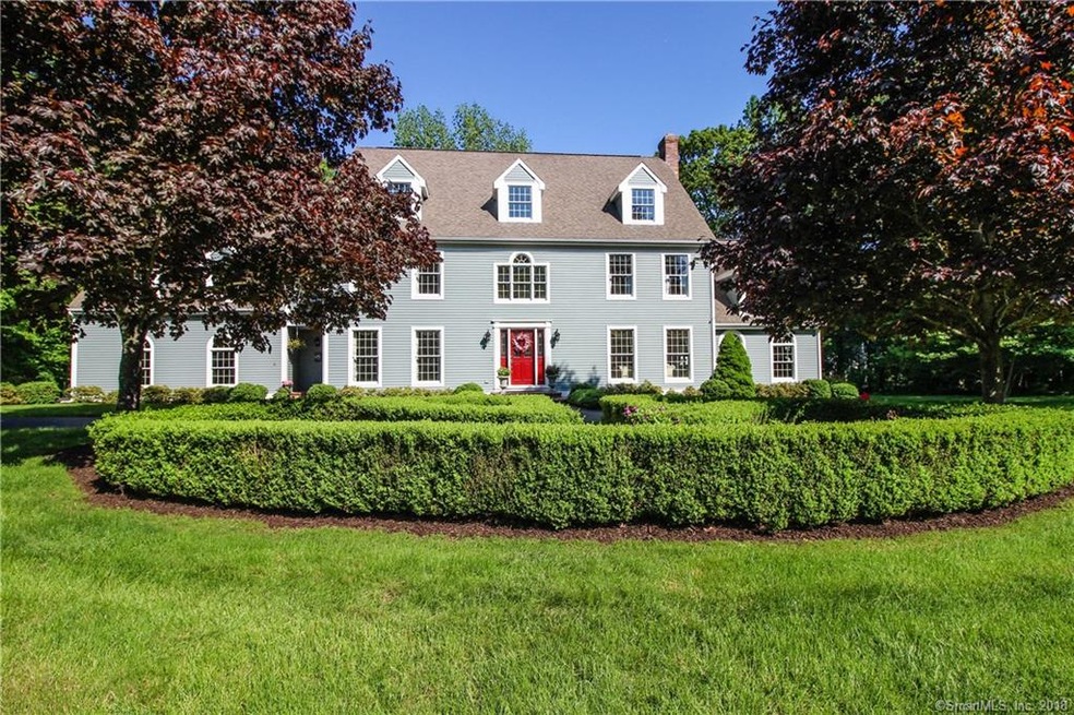 View of home with garden and circular drive