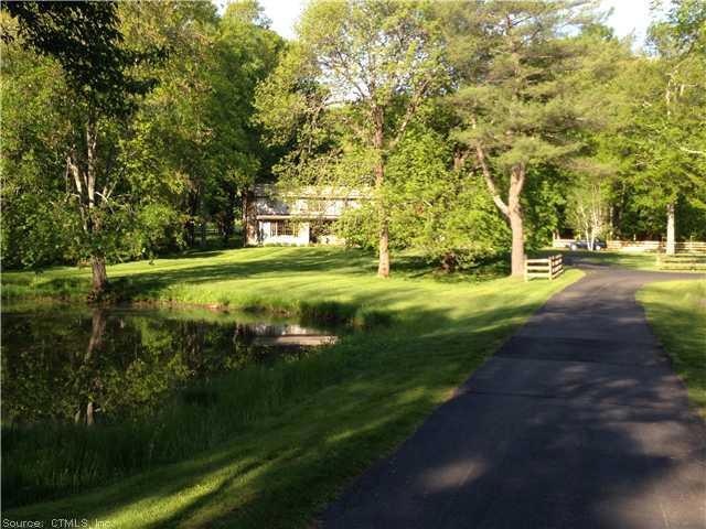 Exterior Front. Summer view of drive into property