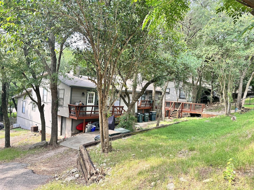 View of grassy yard featuring a deck, central AC 