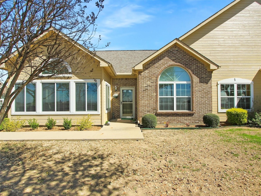 View of front of home with brick siding and a shin