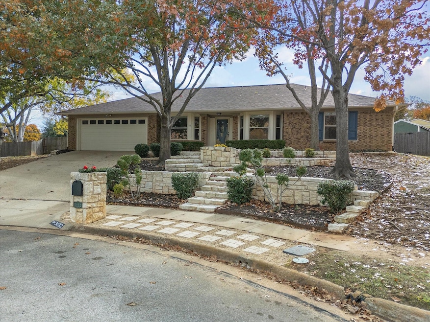 Ranch-style house featuring extensive stone terracing and landscaping