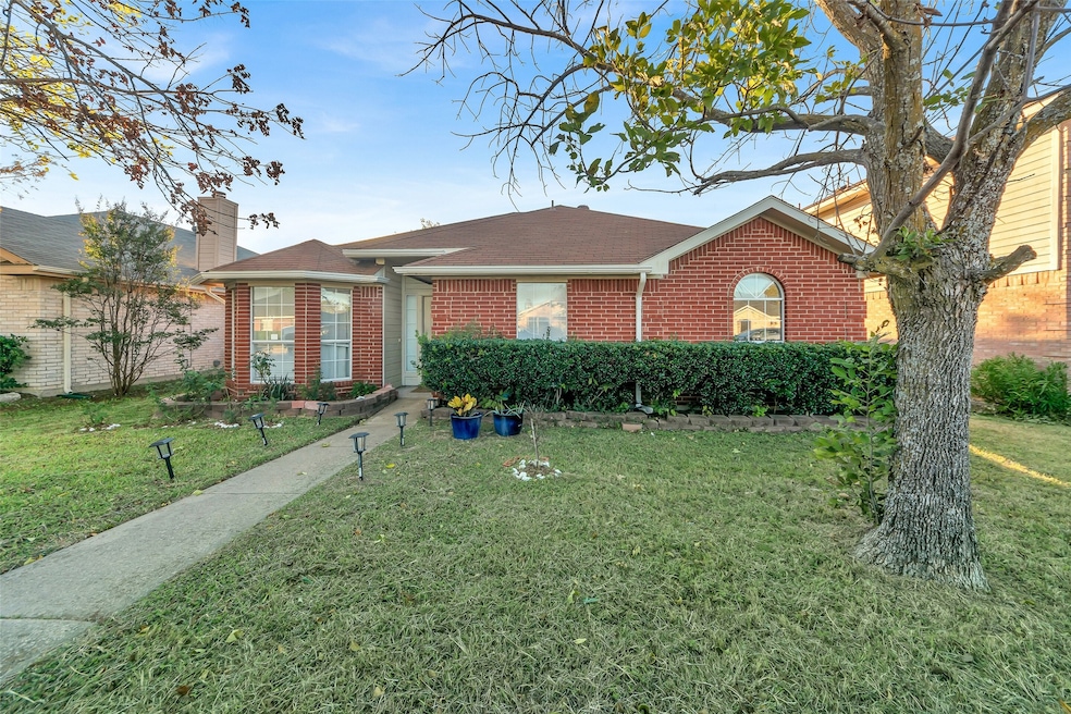 Ranch-style home featuring a front yard and brick siding