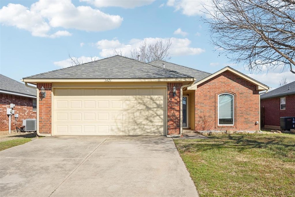 Ranch-style house with a garage, cooling unit, and