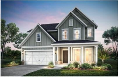 Craftsman-style home featuring board and batten siding, asphalt driveway, an attached garage, and a porch