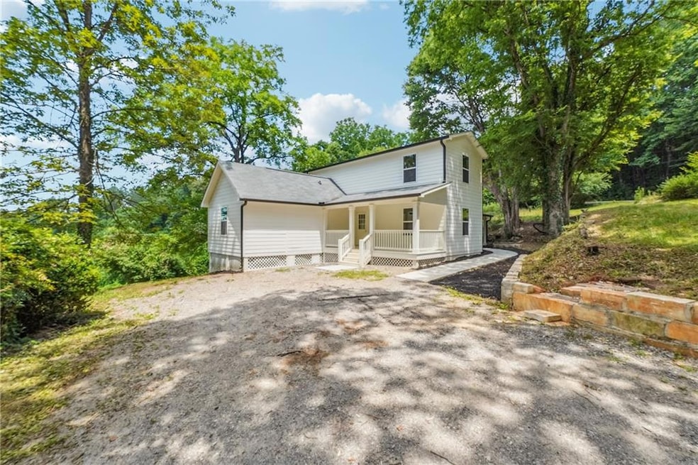Farmhouse-style home with covered porch and driveway