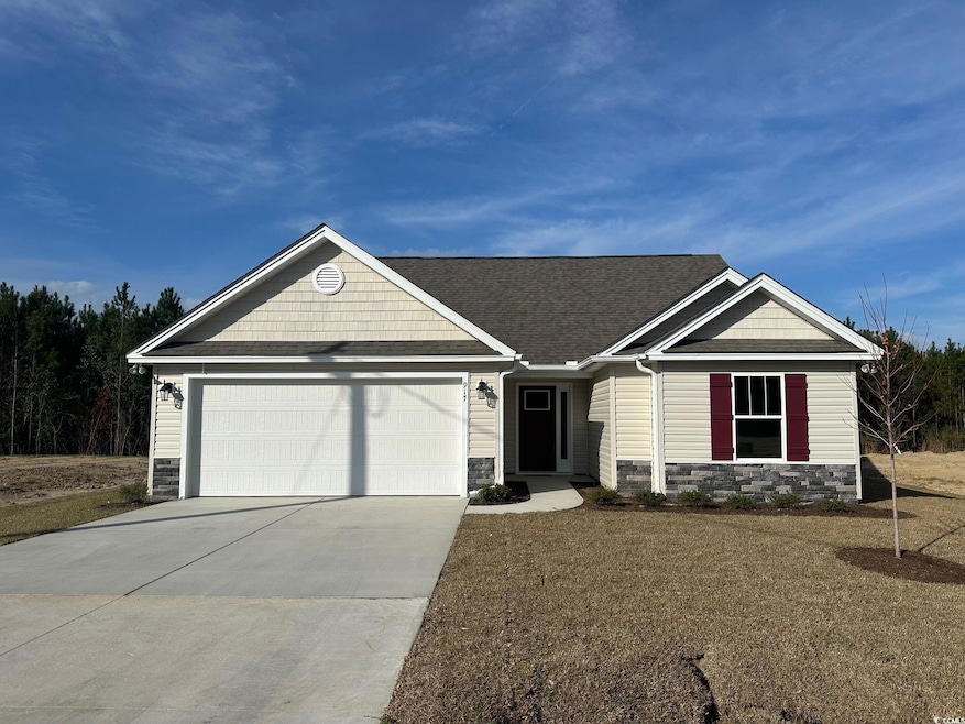 View of front of home featuring a shingled roof, s