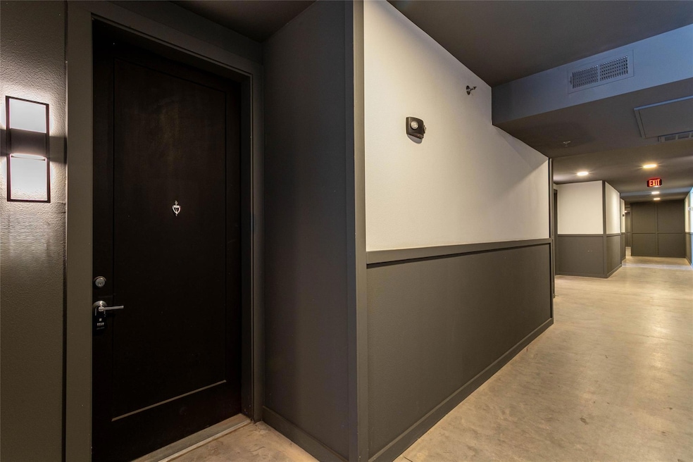 Hallway featuring finished concrete flooring