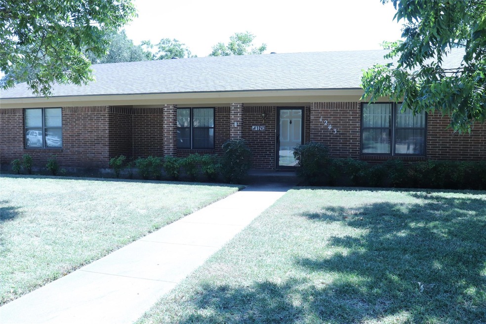 Ranch-style home with a front lawn