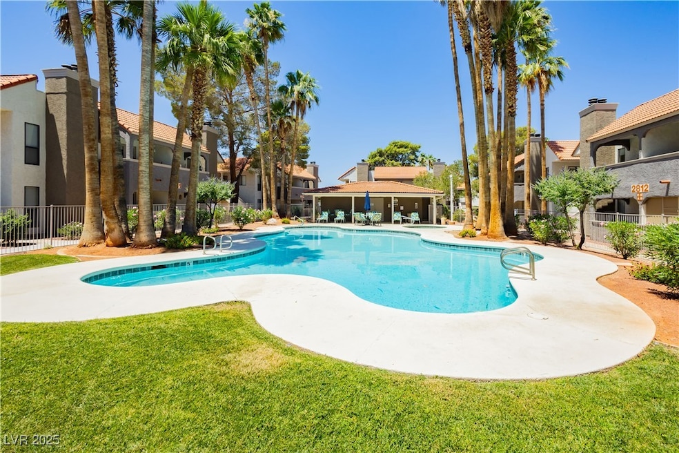 Community pool with a residential view and a patio